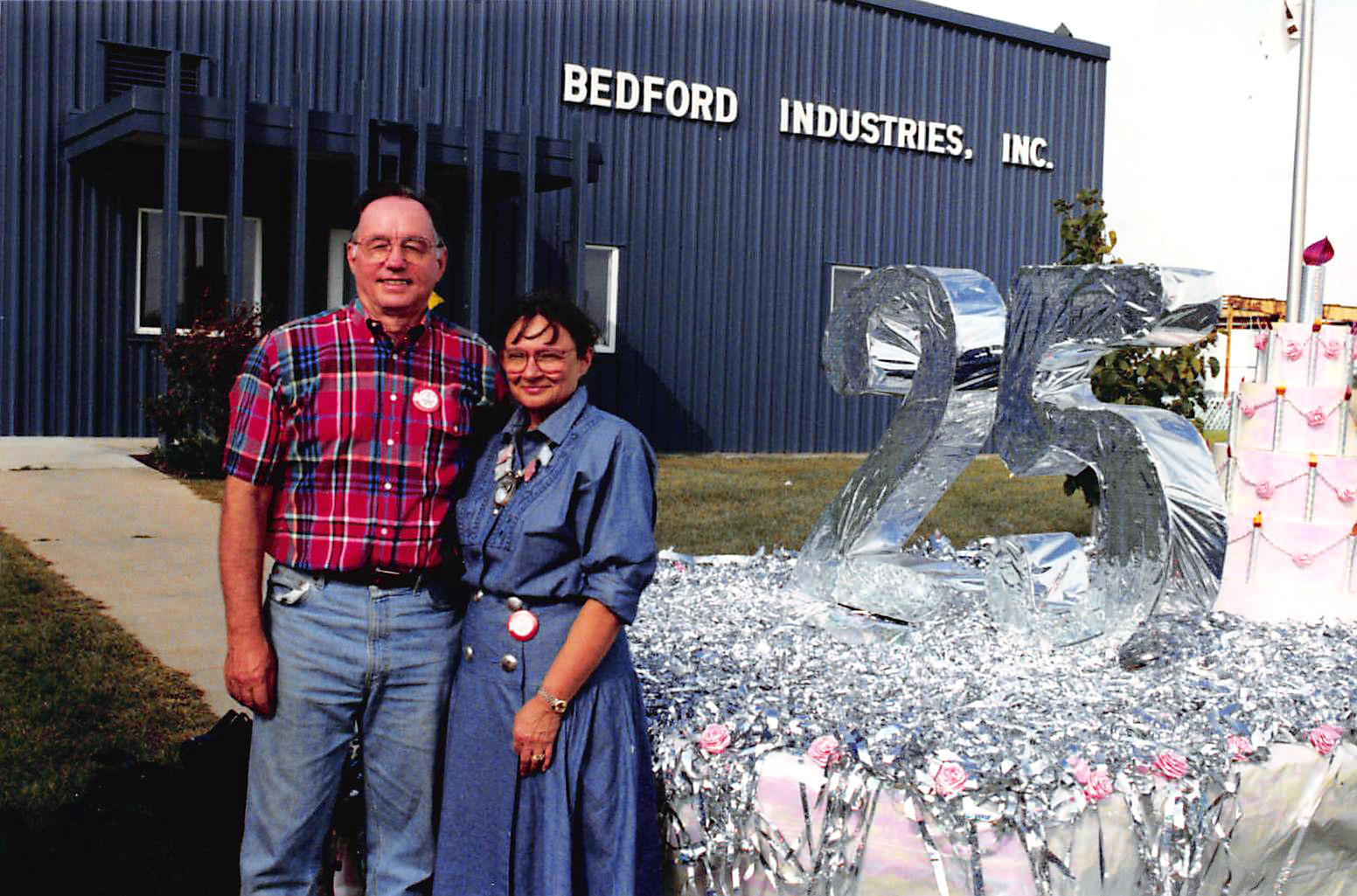 Photo of Bob and Pat Ludlow in front of Bedford building