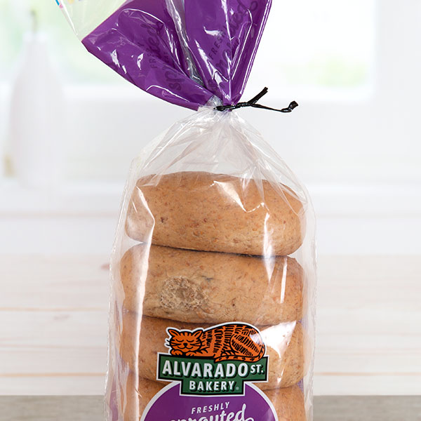 A black plastic twist tie closing a bag of Alvarado St. Bakery branded bagels.