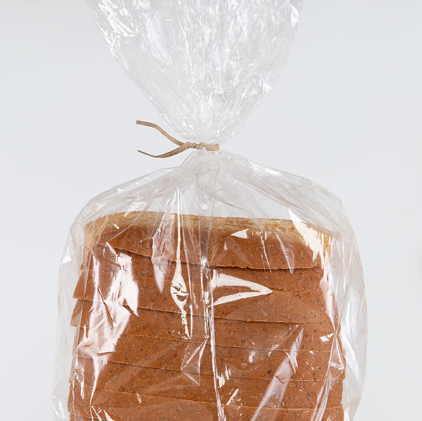 A tan twist tie closing a bread bag.