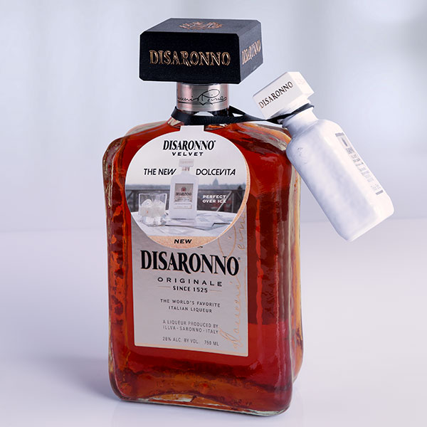 A sample bottle of Disaronno Originale Italian Liqueur attached with an ElastiTag tote as a free sample on a bottle of Disaronno Velvet.