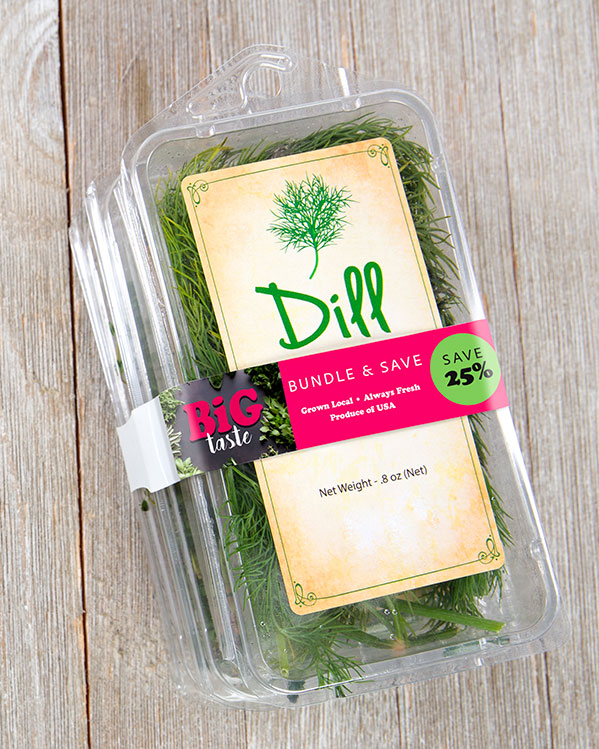 A clear plastic container of fresh dill with a second container being held to it with a bright pink ElastiTag band.